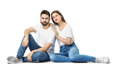 Wall Mural - Stylish young couple in jeans on white background