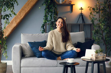 Cute Smiling Woman Is Learing Yoga At Home