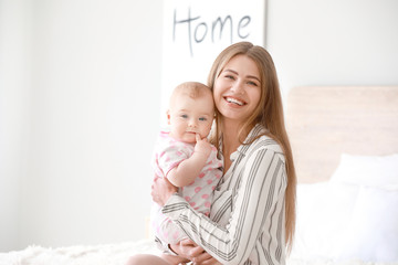 happy mother with cute little baby at home