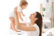 © Pixel-Shot - Happy mother with cute little baby at home