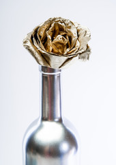 Luxury wine. Metallic steel color. Floral shop. Abstract art. Eternal beauty. Fashion bouquet. Winery concept. Floral wine. Metal flower in steel wine bottle. Forging and sculpture. Alcohol drink