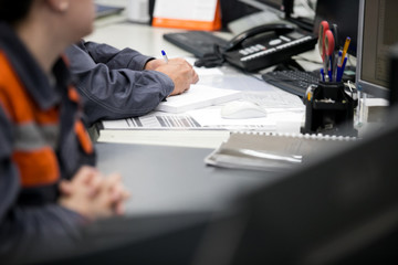 Engineering works with the tablet in the production control room.Control room of a steam Turbine,Generators of the coal-fired power plant for monitor process, business and industry concept