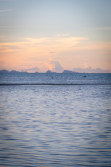 Wall Mural - Beautiful beach sunset with blue sea and golden light sky  cloud background