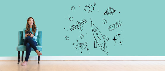 Wall Mural - Dream of space and rocket with young woman holding a tablet computer