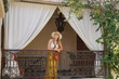 © goodluz - Stylish woman on balcony in Moroccan riad