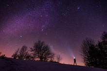 A Man Watching The Milky Way With A Headlight On. Adventurous Photo Of A Starry Night. Stars On The Sky And A Man Watching Them.