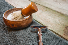 Shiny Safety Razor, Shaving Brush And Lather In Bowl. Old-school Wet Shaving In Rustic Wooden Table, With Copy Space.