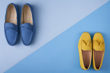 Blue Suede Man's And Yellow Woman's Moccasins Shoes Over Blue Background