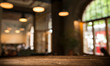 © kishivan - blurred background of bar and dark brown desk space of retro wood