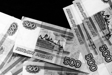 Russian banknotes of five hundred rubles on a dark background close up. Black and white