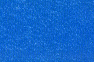 close view of a blue iron on patch for repairing torn clothing