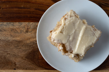 Wall Mural - Serving of banana bread with icing on a plate