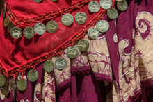Background Of Draped Gypsy Shawls With Decorative Coin And Bead Fringe And Distinctive Weave For Each Piece - Red And Burgundy Colors With A Batik And Embroidery Edge On One - Boho Belly Dancing