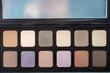 Neutral color eye shadows palette on grey background