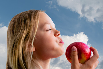 Girl eating a red juicy Apple