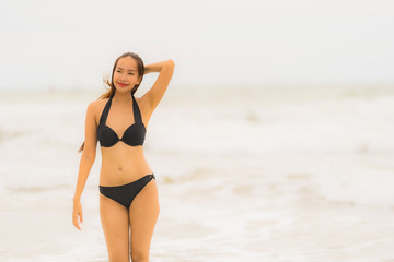 Portrait beautiful young asian woman wear bikini on the beach sea ocean