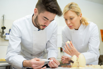 Wall Mural - two chefs working with chocolate