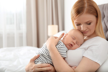 Wall Mural - Mother with her sleeping baby in bedroom