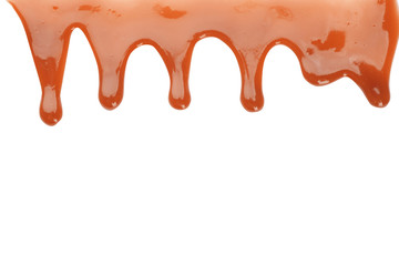 Delicious caramel sauce flowing on white background