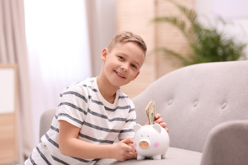 Poster - Little boy with piggy bank and money at home