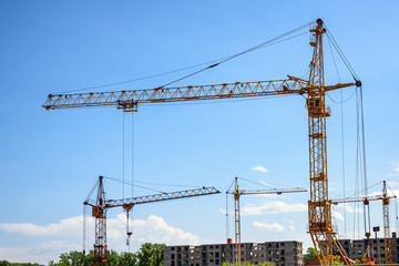 construction site of a residential multi-storey building with tower cranes