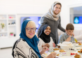 Wall Mural - modern multiethnic muslim family having a Ramadan feast