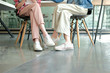 girl teenager legs wearing sneakers sitting talking together