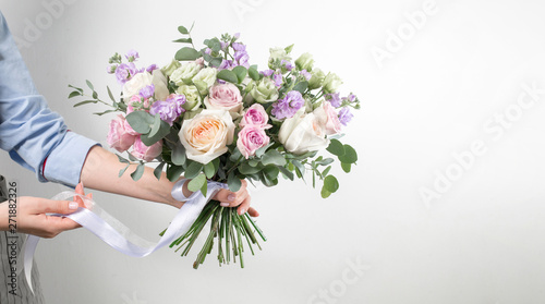 Florist holding a bouquet. Beautiful spring flowers. Arrangement with mix flowers. The concept of a flower shop, a small family business. Work florist. copy space