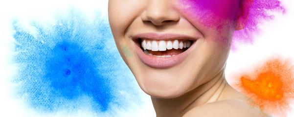 Laughing woman with great teeth with hand drawn multicolored watercolor elements and copy space for text message over white background. Healthy beautiful female smile.