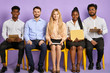 © alfa27 - group of multicultural young people sitting straight and looking in camera waiting for job interview