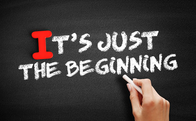 It's Just The Beginning text on blackboard, concept background