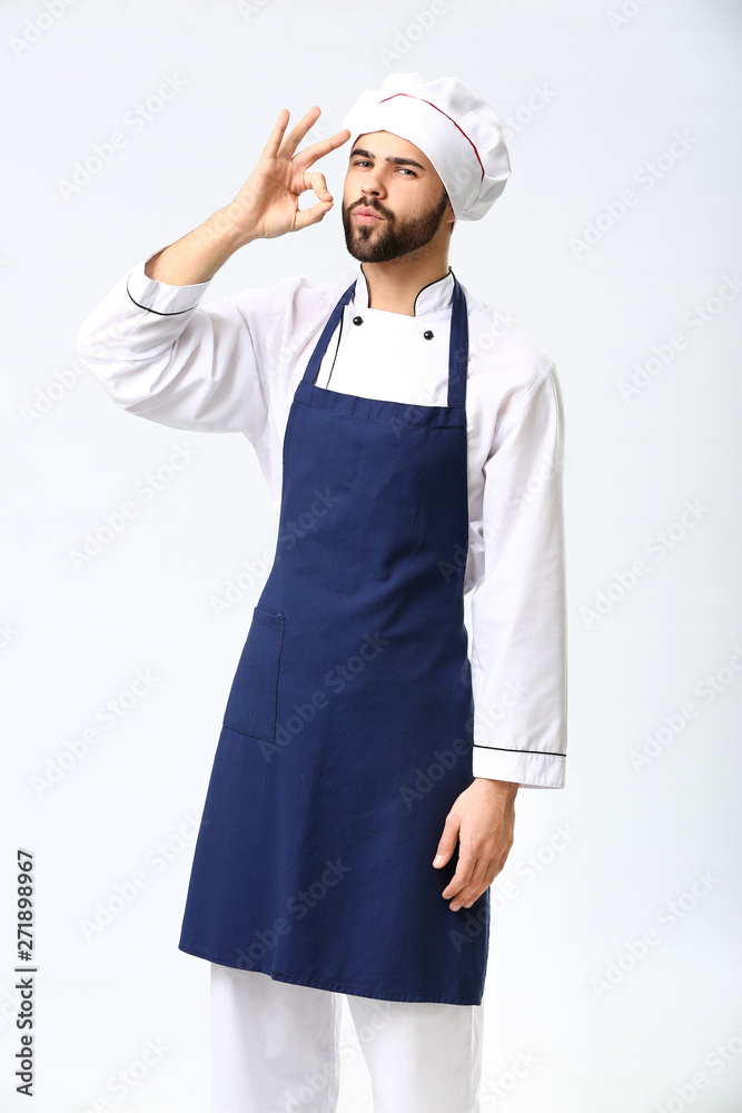Handsome male chef on white background