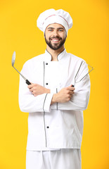 Wall Mural - Handsome male chef on color background
