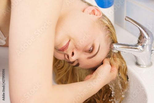 Woman Washing Hair In Bathroom Sink Buy This Stock Photo