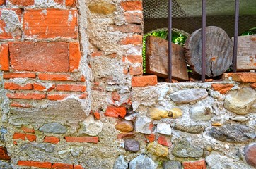 background from piece of the ancient stone - and- brick wall and window with bars