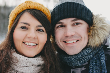 The happy couple in love at forest nature park in cold season, close up. Travel adventure love story