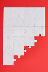 Wall Mural - top view of white connected puzzle pieces isolated on red