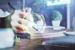 © peshkova - Double exposure of woman's hands on background with technology and digital coding icons. Data development concept. Close up.
