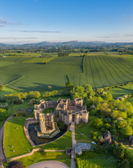 Wall Mural - Aerial panoramic view of the ruins of Raglan castle, a late medieval castle located just north of the village of Raglan in the county of Monmouthshire in south east Wales, UK