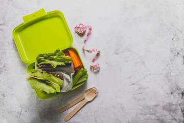 Wall Mural - Top view of lunch box with measuring tape and cutlery