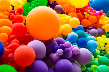 Wall Mural - Jumble of rainbow colored balloons celebrating gay pride in a textured background