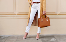 Closeup Female Legs. Woman In Coat With Bag. Fashion Outfit