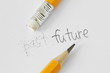 The word past erased with a rubber and the word future written with a pencil on white paper - Concept of time, clearing the past and building a future