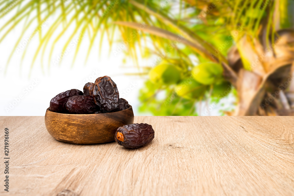 Close up photo of dates, date fruits in bowl and on the wooden table ...