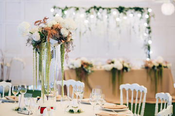 Wall Mural - Gorgeous luxury wedding table arrangement, floral centerpiece close up. The table is served with cutlery, crockery and covered with a tablecloth. Wedding party decoration with pink and white flowers.