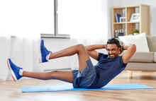 Sport, Fitness And Healthy Lifestyle Concept - Indian Man Making Abdominal Exercises At Home