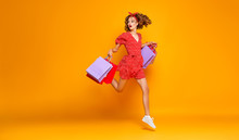 Concept Of Shopping Purchases And Sales Of Happy Young Girl With Packages  On Yellow Background