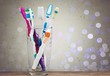 New Colorful Toothbrushes in A Glass  on  Background
