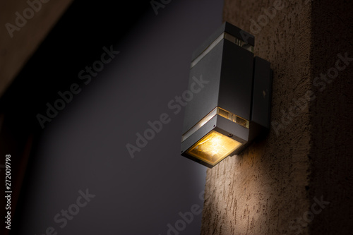 Fotomural Cubical looking lantern placed on the exterior of a building during night time w