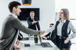 © Тарас Нагирняк - Business people shaking hands, finishing up a meeting. New manager in office.